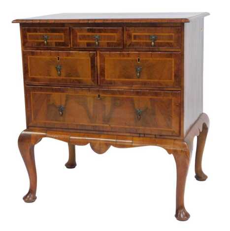 An 18thC walnut and cross-banded chest, the top with a moulded edge above an arrangement of six drawers, on cabriole legs with pad feet, adapted from a large piece, etc, 92cm high, 83cm wide, 60cm deep.