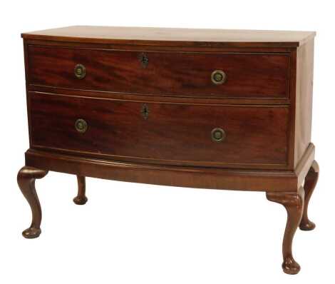 A mahogany bow front chest, of two short drawers, on cabriole legs on pad feet, 82cm high, 105cm wide, 53cm deep.