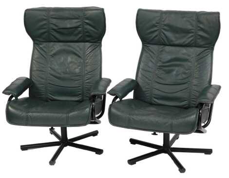 A pair of Kebe Danish armchairs, each with green leather upholstery, on metal base, 69cm wide. The upholstery in this lot does not comply with the 1988 (Fire & Fire Furnishing) Regulations, unless sold to a known exporter or upholsterer it will be cut fro