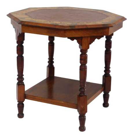 An Edwardian walnut and marquetry occasional table, the octagonal top inset with a brown painted panel surrounded by boxwood inlaid ivy leaves, with square under tier, on turned cylindrical legs, 68cm high, the top 75cm x 75cm.