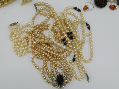 A group of assorted costume jewellery, comprising cultured pearl necklace with 9ct clasp, clip on earrings, bangles, faux pearl necklaces, crystal longuards, Swarovski crystal pendant and chain, Newbridge silver pendant and chain, Mappin and Webb wristwat - 9