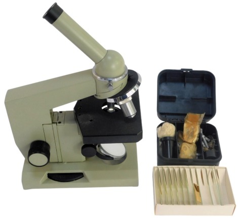 A Nomo cased microscope, N885254, 33cm high, together with various slides, etc., the case 36cm high, locked.