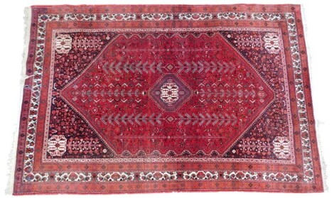 A Persian rug, blue ground, decorated centrally with multiple medallions within multiple wide and narrow borders, 297cm x 200cm.