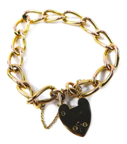 A charm bracelet, the elongated and hammered figaro links, with heart shaped padlock and safety chain, yellow metal stamped 9ct, 18cm long, 29.4g.