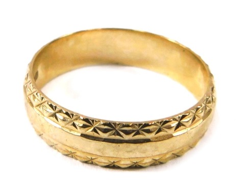 A 9ct gold wedding band, of etched design, with raised centre band, London 1956, ring size P, 2.7g all in.