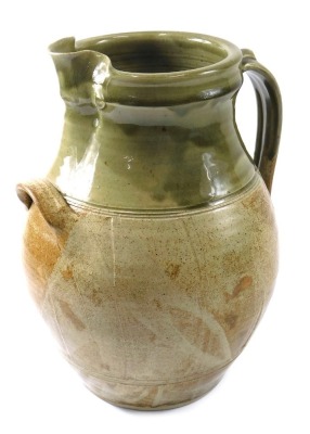 A large Studio Pottery ewer, with brown and green glazes, a small handle and larger moulded handle, stamped to underside Sam Dales Y2K, 33cm high.