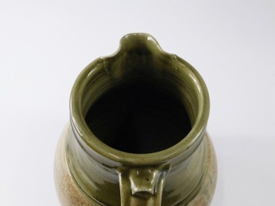 A large Studio Pottery ewer, with brown and green glazes, a small handle and larger moulded handle, stamped to underside Sam Dales Y2K, 33cm high. - 2