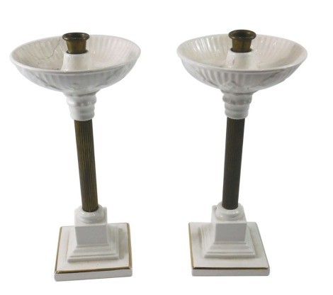 A pair of brass and pottery candlesticks, each with a leaf moulded sconce, and a reeded column on a stepped base, one AF, 34cm high.