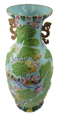 A 20thC Chinese style two handled vase, decorated in relief with water lilies, birds, etc., unmarked, 46cm high.