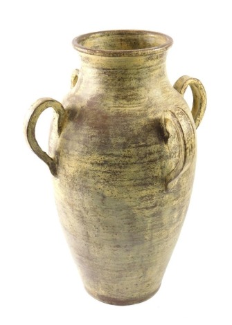 A cream and brown glazed studio pottery vase, with four handles, 54cm high.