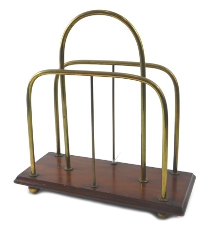 An Edwardian mahogany and brass two division Canterbury or magazine rack, on ball feet, 35cm wide.