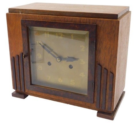 An Art Deco style teak and burr wood mantel clock, 28cm wide.