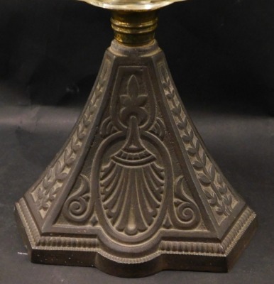 A late Victorian/early 20thC cast iron and clear glass oil lamp, with chimney, 54cm high overall. - 2