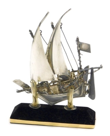 A white metal model of a sailing ship, on mounted base, unmarked.