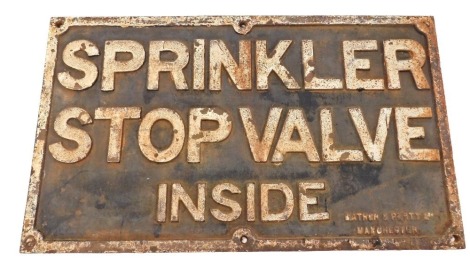 A cast iron sign, stamped Sprinkler Stop Valve Inside, made by Mather & Platt Ltd of Manchester, 56cm wide, 32cm high.