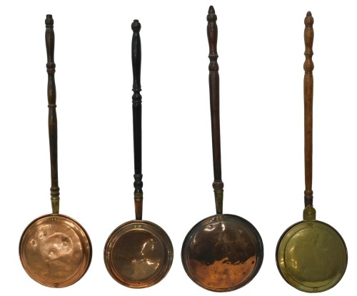 Four 19thC copper and brass warming pans, each with a turned wooden handle.