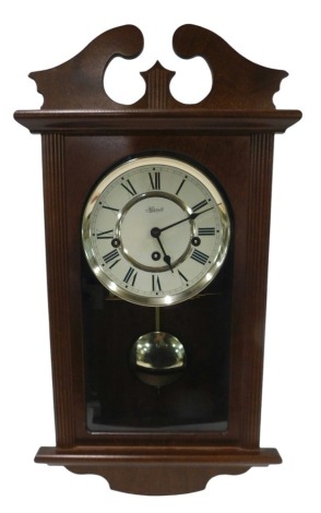 A Hermle mahogany cased wall clock, with Westminster chime, 48cm high.