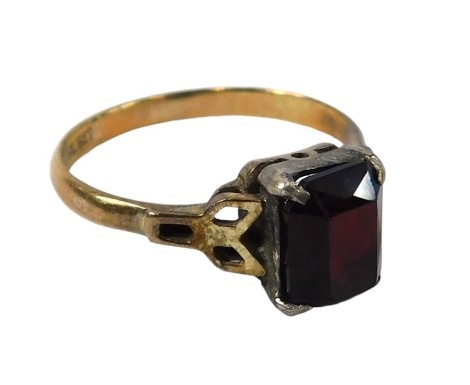 A garnet set dress ring, the rectangular garnet in raised claw basket setting, with V splayed shoulders, stamped 9ct gold sil, ring size P, 2.4g all in.