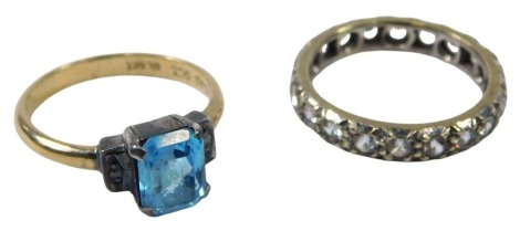 Two dress rings, comprising a blue paste stone set Art Deco style dress ring, the yellow metal band stamped 9ct sil, ring size M, and a 9ct gold and sil eternity ring, set with paste stones, ring size M½, 5.8g all in.