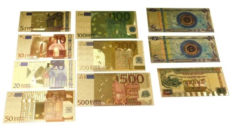 A group of gold coloured banknotes, in display cases.