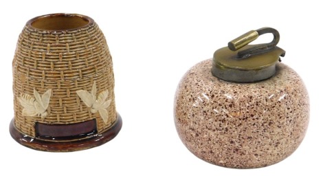 A ceramic inkwell, formed as a curling stone, with brass capped top, 6cm high, and a Doulton Lambeth beehive match strike, 6cm high. (2)