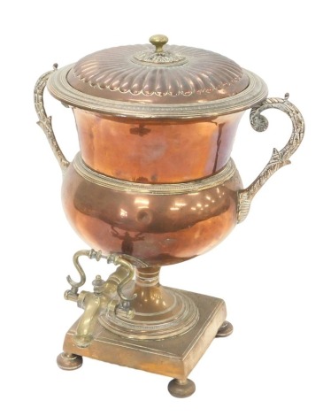 A 19thC copper and brass tea urn, with leaf cast shaped handles, on bun feet, lid associated, 40cm high.