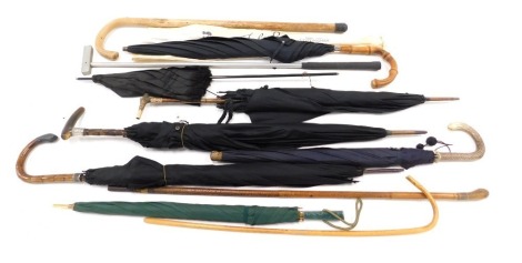 Various walking sticks and parasols, comprising a horn handled and white metal collared parasol, a horn handled and yellow metal collared parasol, and various other walking canes. (a quantity)