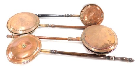 Four 19thC copper warming pans, 90cm long. (4)