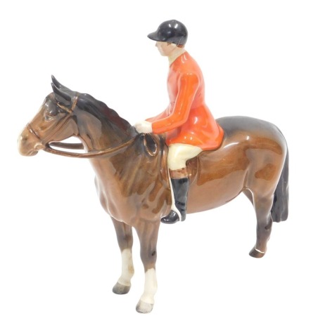 A Beswick huntsman figure, mounted on horseback with Beswick sticker, 20cm high. (AF)