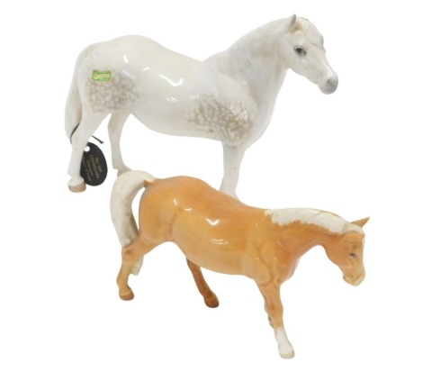 Two Beswick horses, comprising a Connemara, 16cm high, and a tan mare, 11cm high. (2, AF)