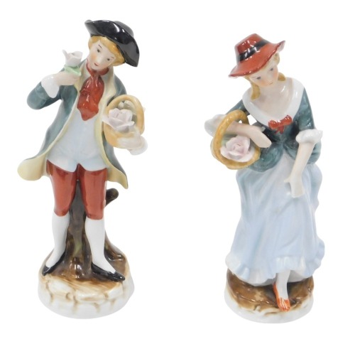 A pair of Continental porcelain figures, depicting girl and boy carrying basket of roses, blue stamp to underside, 18cm high. (2)