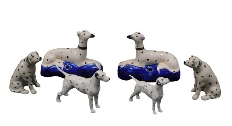 A pair of 19thC Staffordshire style seated spaniels, 11cm wide, two Beswick dalmatians, and a pair of modern dalmatian salt and pepper pots. (6)