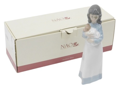 A Nao figure group of a girl carrying puppy in cloth, boxed, 22cm high.