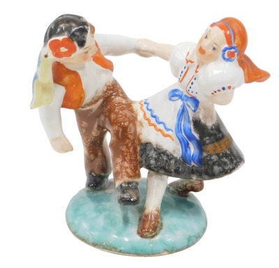 A Czechoslovakian figure group of two figures, swinging on base, 14cm high.