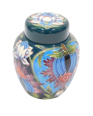 A Moorcroft ginger jar and cover, on a emerald green ground, decorated with flowers by William Moorcroft, dated 2001, 17cm high.