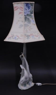 A Nao lamp, mounted with stork and two geese figures, with a floral shade, 50cm high.