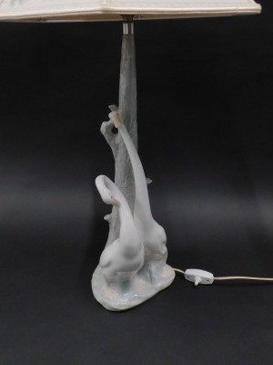 A Nao lamp, mounted with stork and two geese figures, with a floral shade, 50cm high. - 2