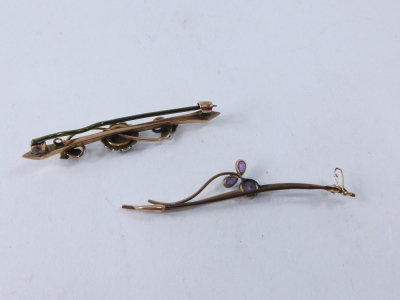 Two bar brooches, comprising an amethyst and seed pearl floral cluster bar brooch, yellow metal unmarked, and an amethyst grape vine type swirl brooch, yellow metal, unmarked, 5cm and 6cm long, 4.2g all in. - 2