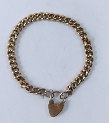 A curb link charm bracelet, with heart shaped padlock, the padlock only stamped 9ct, the chain 20cm long, 10.4g. - 2