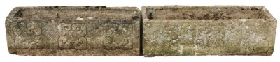 A pair of reconstituted stone garden planters, each with three crested motifs to front, 30cm high, 93cm wide, 31cm deep.