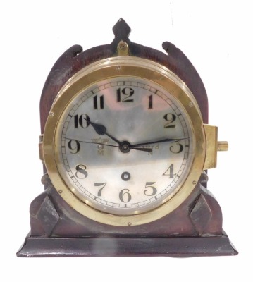 A brass WWII German Kreigsmarine u-boat or submarine clock, the silvered dial with Arabic numerals, engraved with the Third Reich eagle and 1073 N, later mount, the dial 17cm diameter.