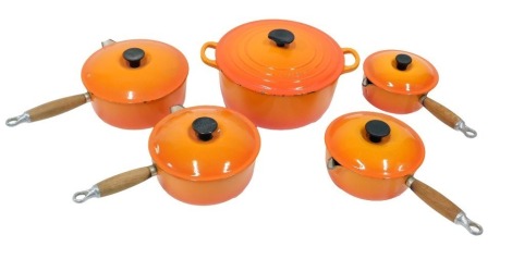 Le Creuset kitchen wares, comprising casserole dish and cover, 29cm diameter, and a set of four pans with lids. (5)