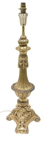 A gilded table lamp, in Neoclassical style, on triform base, 79cm high.