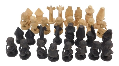 A carved African wooden chess set, seated tribal figures, etc.