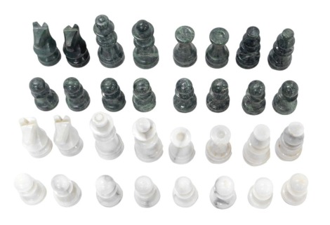 An African carved soapstone chess set, with green chess pieces.