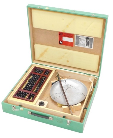 A set of educational items, a Chinese abacus, and scales, the painted box with label ERS for Educational Resource Service, the box 62cm wide.