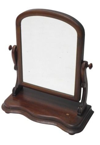 A Victorian mahogany dressing table mirror, an arched plate and a serpentine fronted moulded base, 55cm wide.