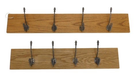 Two sets of pewter coloured metal coat hooks, each on oak backing, 91.5cm and 76cm wide.