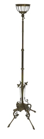 A late 19th/early 20thC brass floor lamp, with fitting for an oil lamp, the base with four pierced and leaf cast legs and ogee feet, 158cm high.