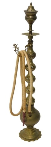 An Eastern engraved and pierced brass hookah pipe, 120cm high.